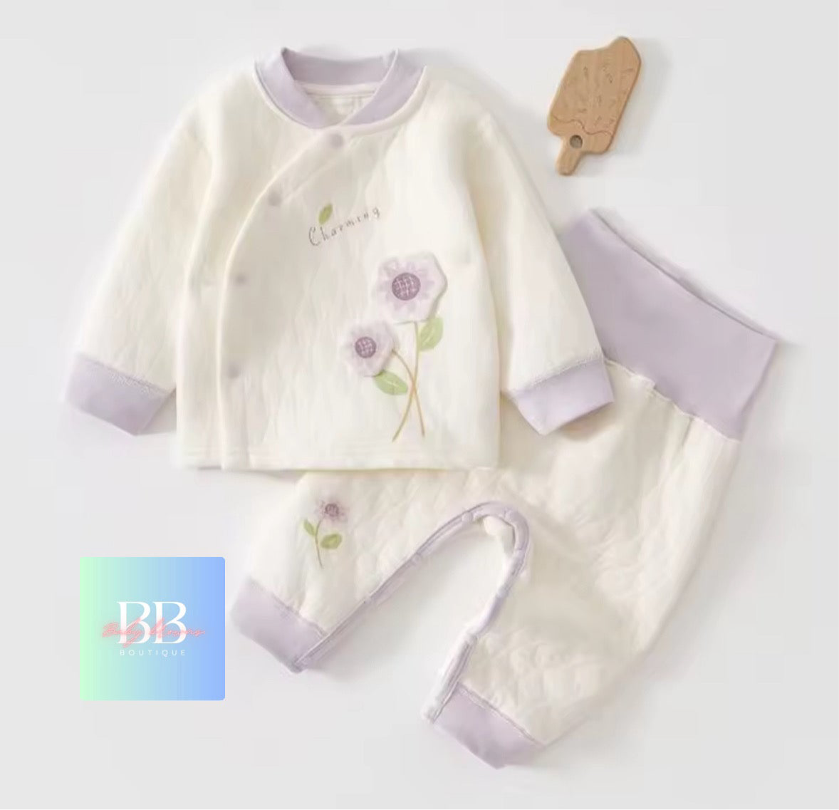 Baby outfit with floral design on a light gray background
