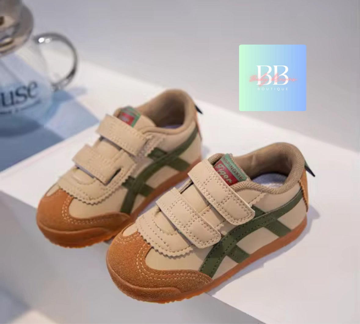 Pair of children's shoes with a visible brand logo on a white surface.