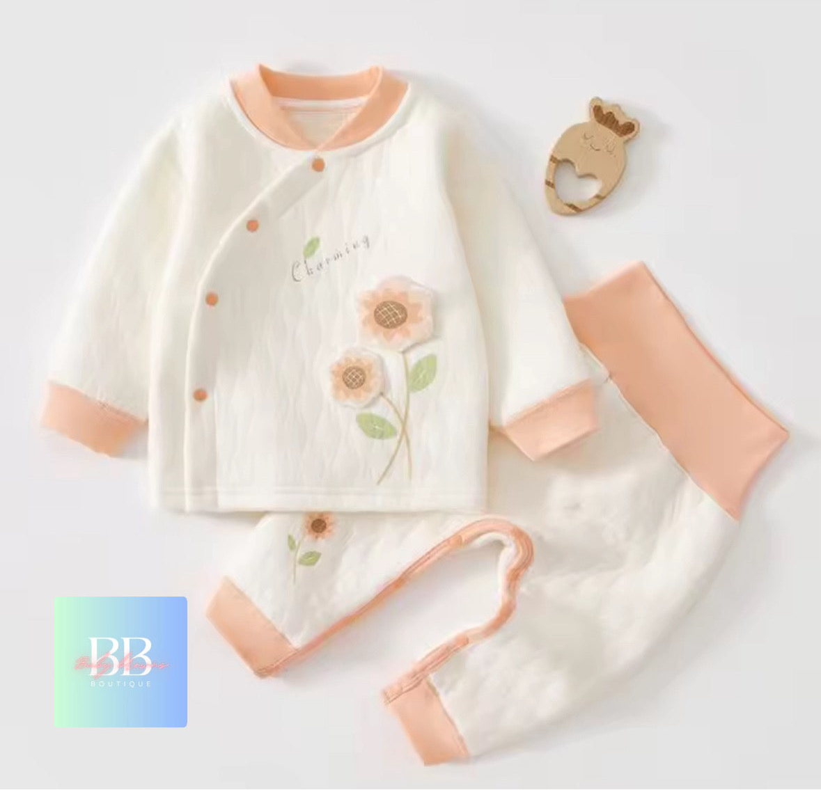 Baby outfit set with floral design on a light background