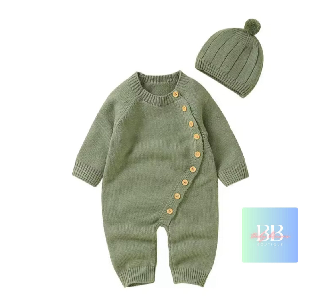 Green baby knitted romper with buttons and matching hat on a white background