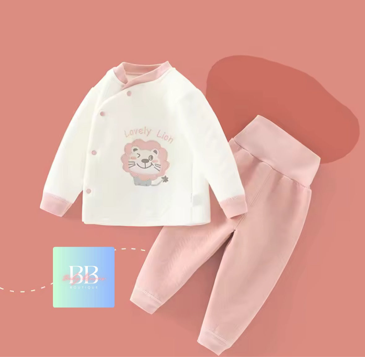 Baby outfit with lion design on a pink background