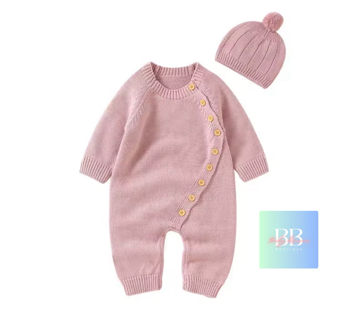 Pink knitted baby romper with buttons and matching hat on a white background