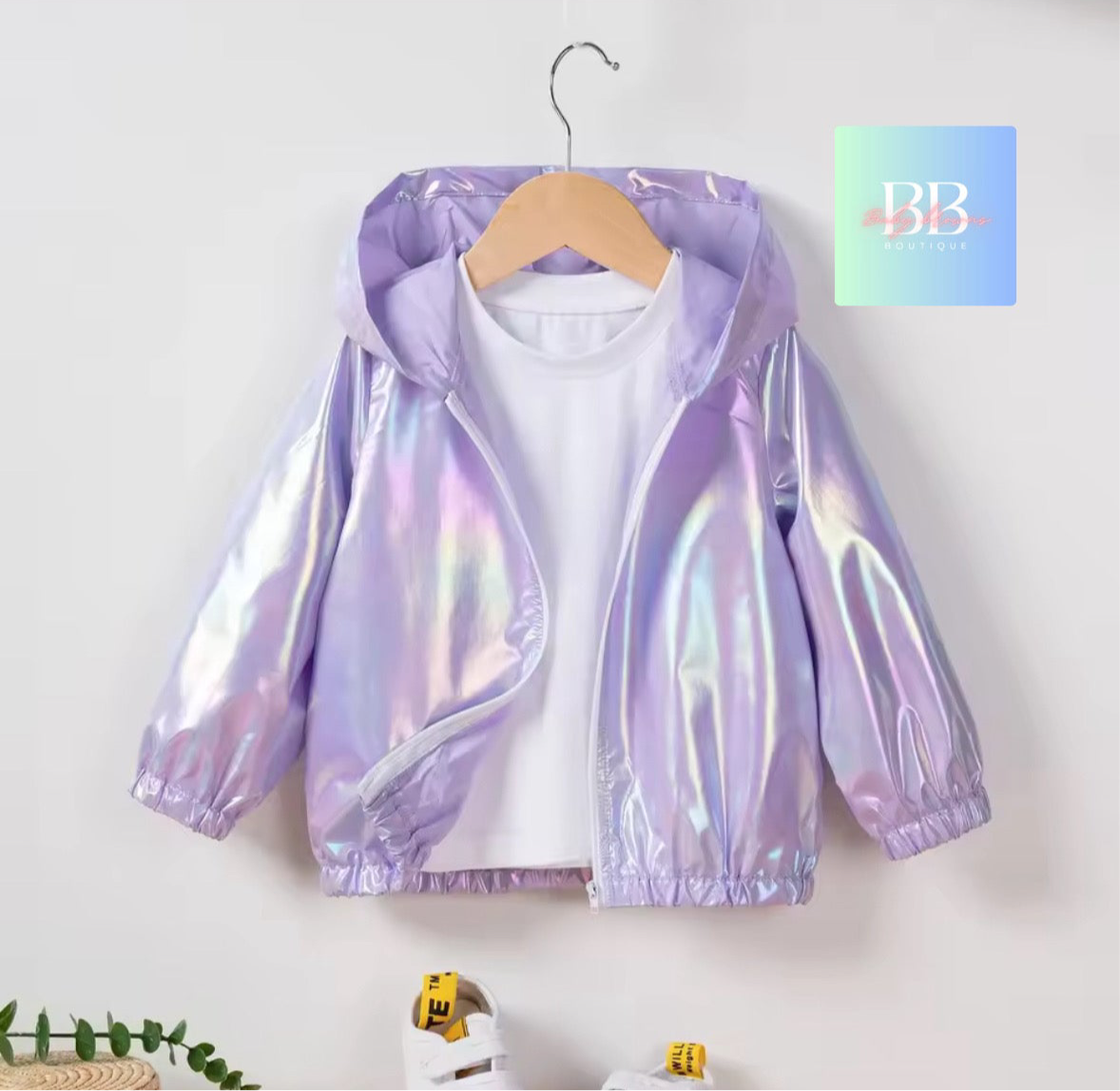 Holographic purple jacket on a hanger with a white background