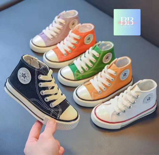 Set of colorful high-top sneakers on a gray surface with a brand logo in the corner.