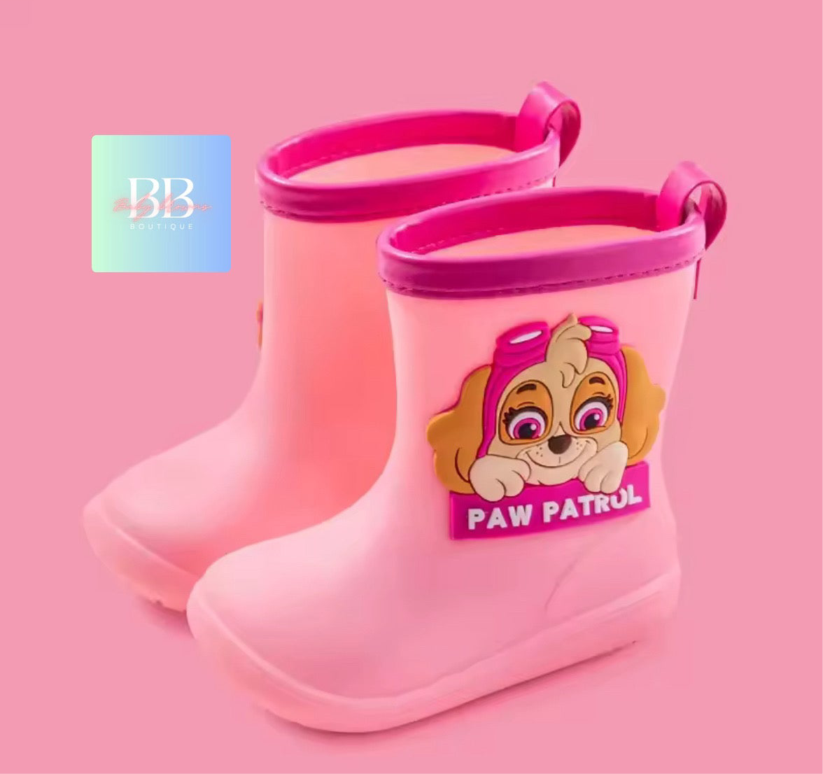 Pink rain boots with a Paw Patrol character on a pink background