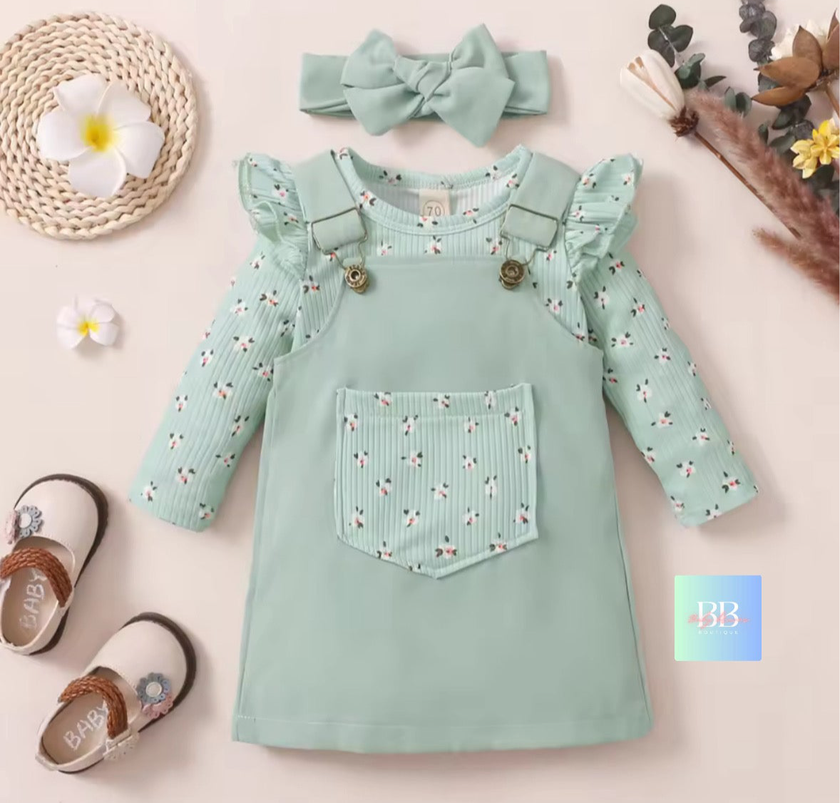 Mint green children's dress with floral pattern, matching headband, and shoes on a light background.