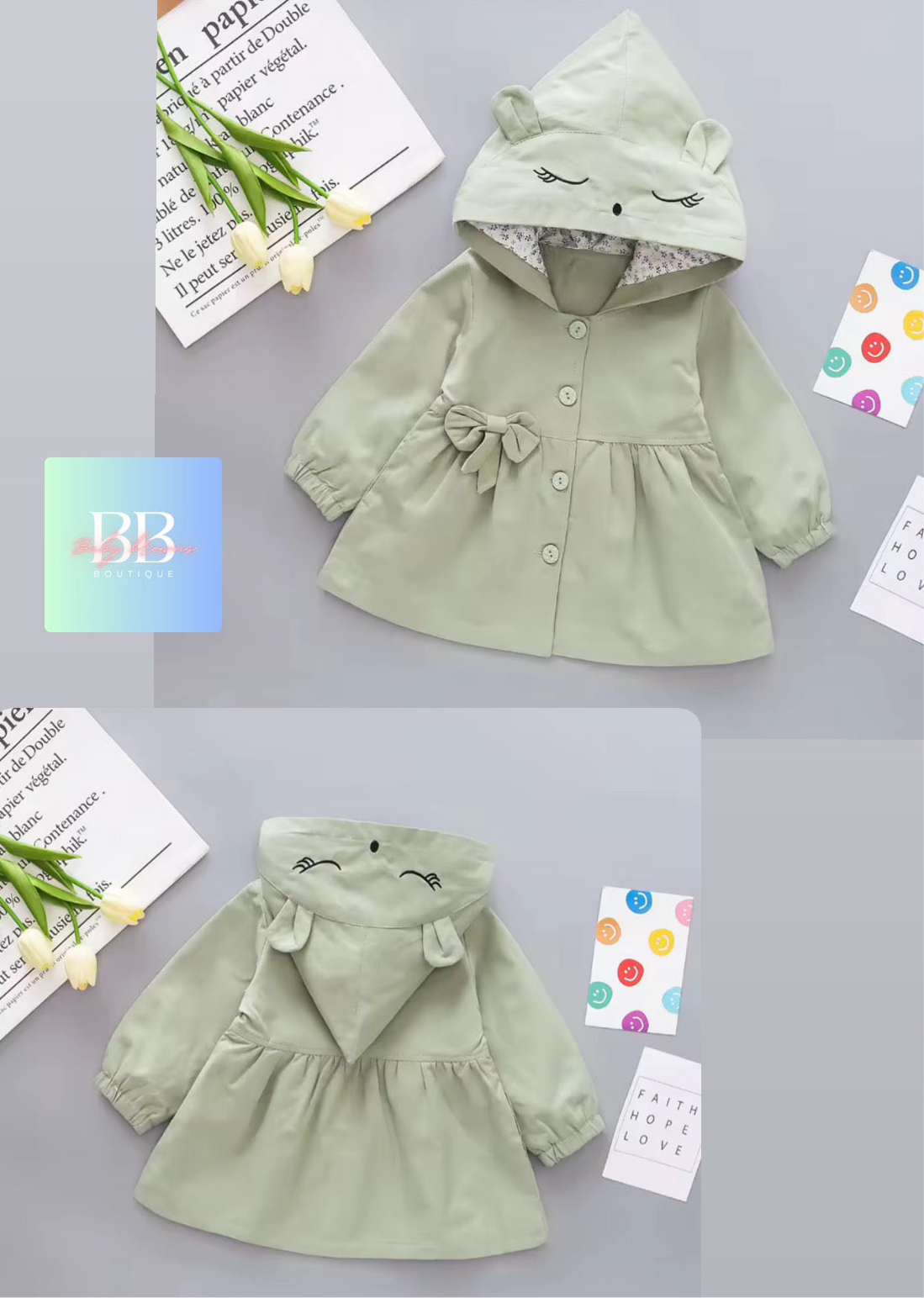 Two green children's hoodies with animal ears on a gray surface.