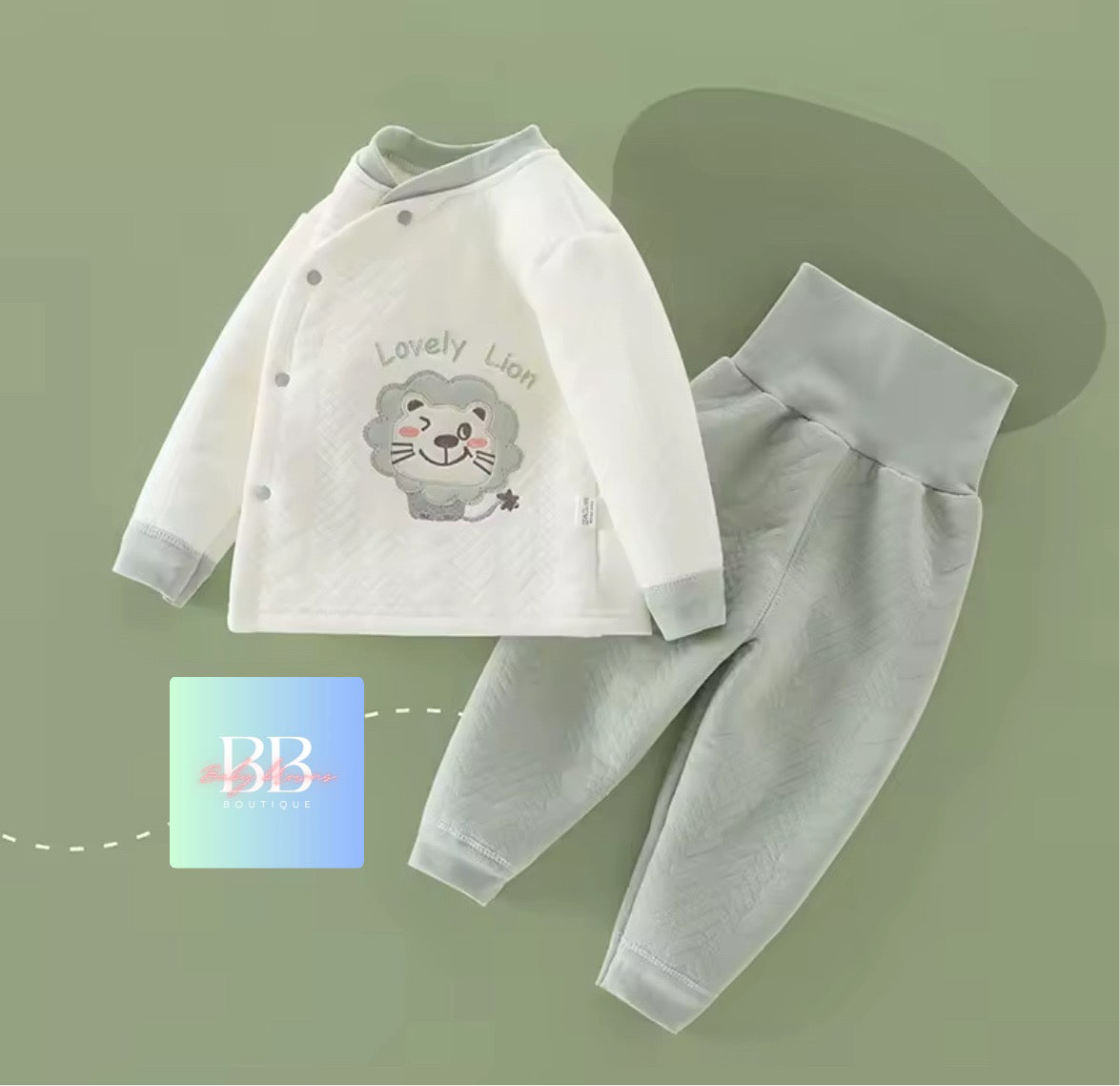 Children's outfit with a shirt and pants on a green background