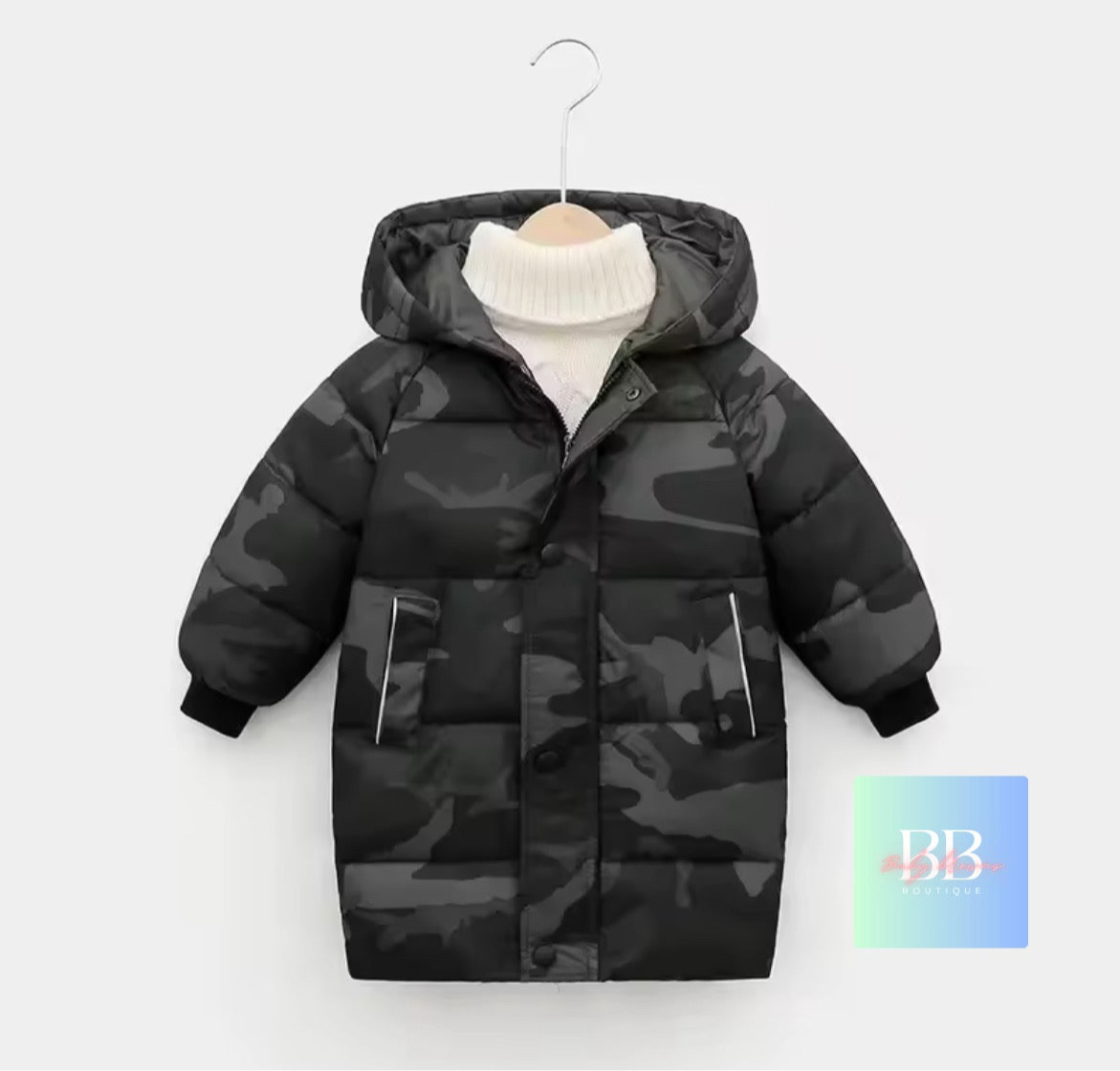 Camouflage-patterned children's puffer jacket on a hanger with a white background
