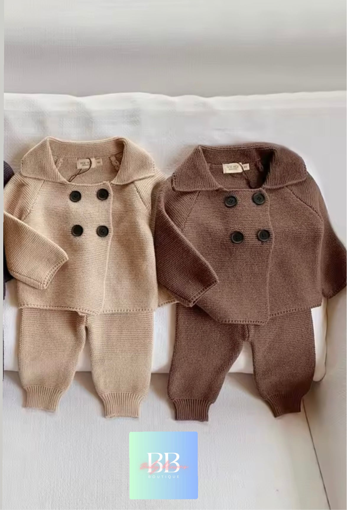 Two children's outfits, one beige and one brown, on a white surface with a brand logo in the corner.