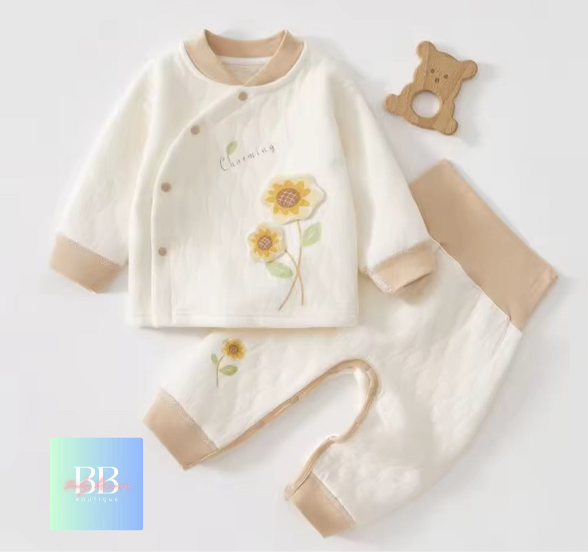 Baby outfit set with floral design on a light background