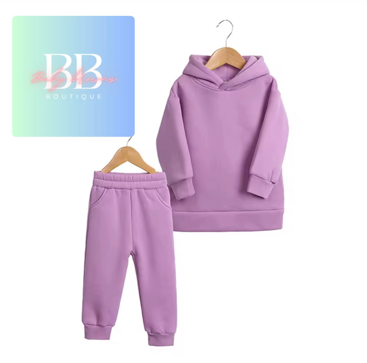Purple hoodie and pants set on hangers with 'BB Boutique' logo in the corner.