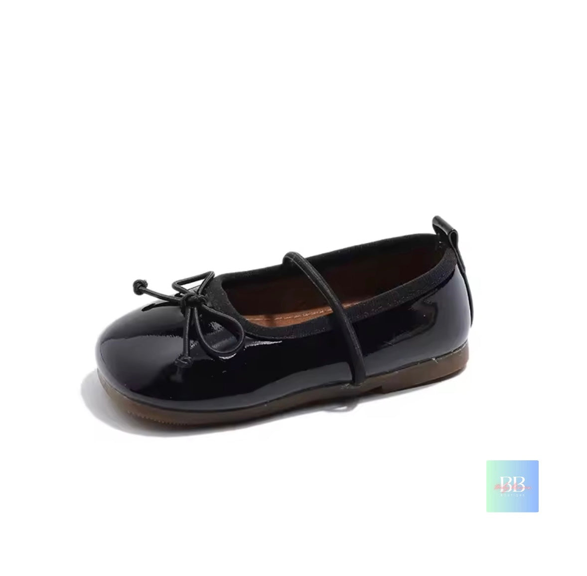 Black patent leather shoe with a bow on a white background