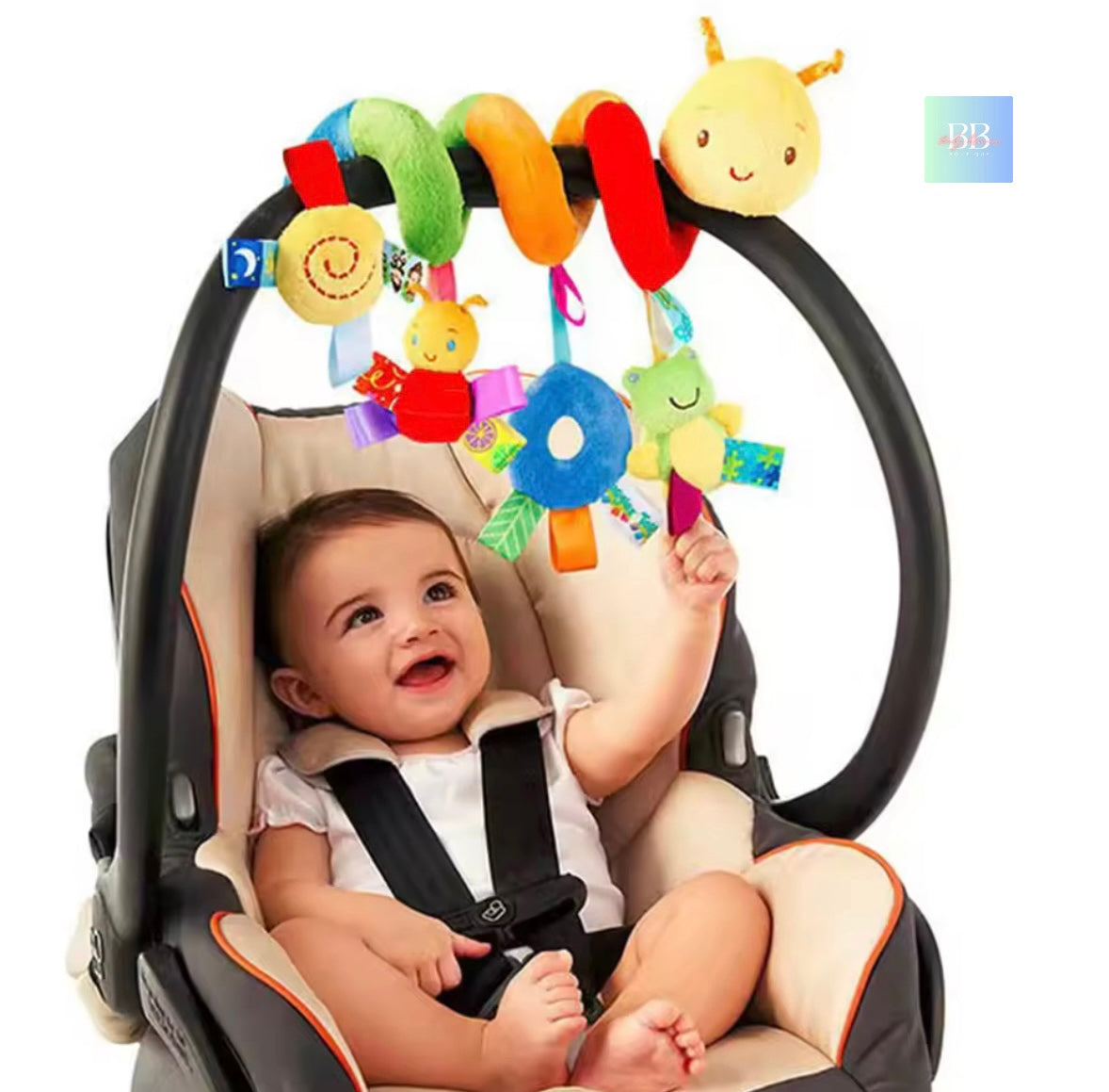 Baby in a car seat with a colorful toy hanging above