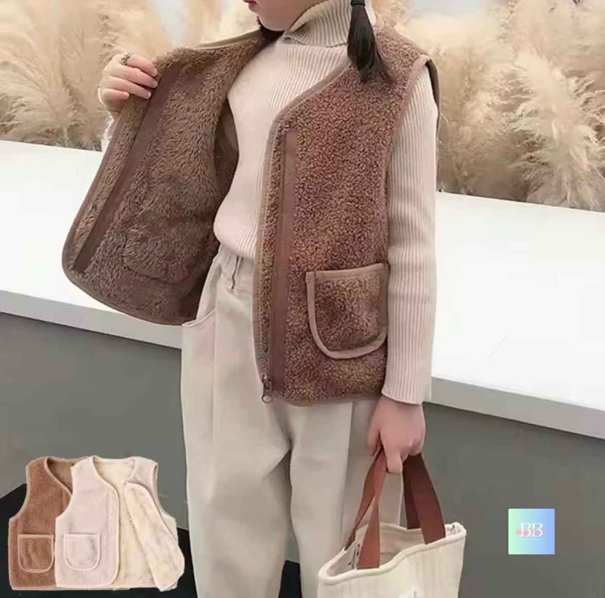 Person wearing a brown fleece vest with a neutral background