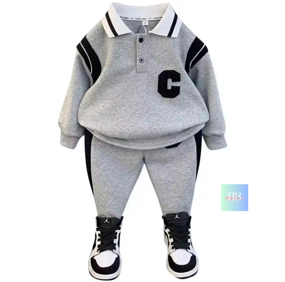 Children's gray outfit with black accents and white sneakers on a white background