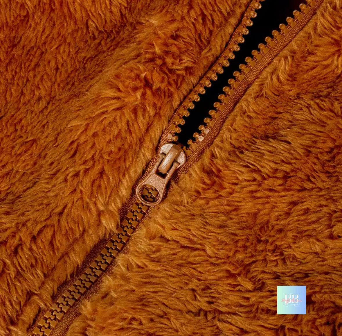 Close-up of a brown fuzzy jacket with a zipper, brand '143' visible.
