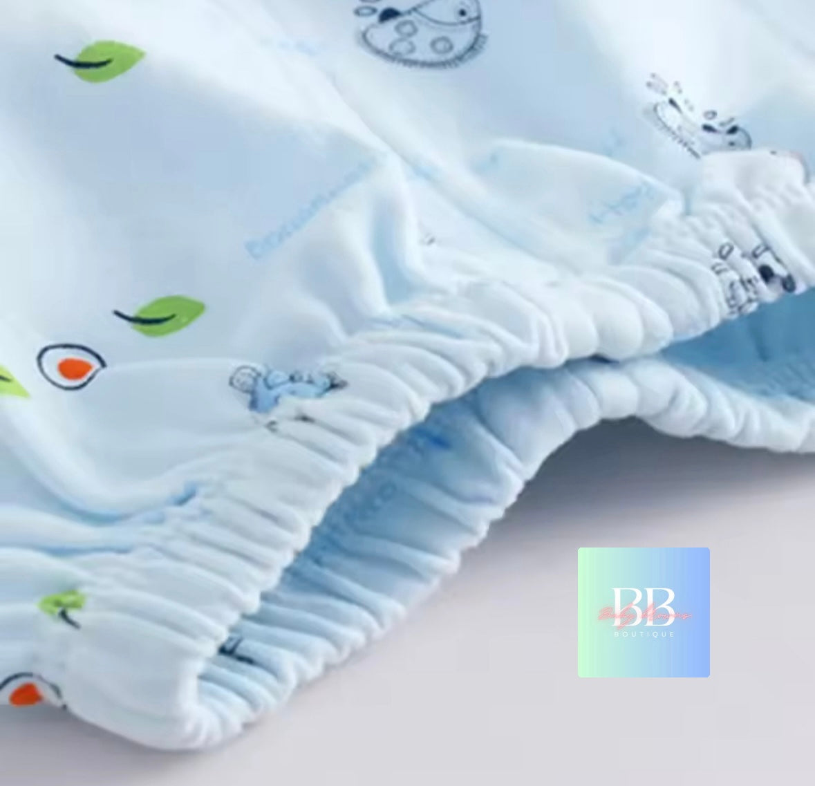 Baby blanket with cartoon designs on a light background