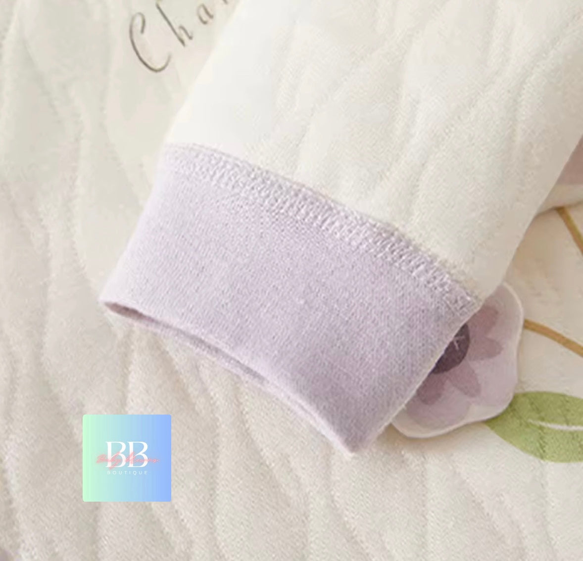 Close-up of a textured white fabric with a brand logo in the corner.