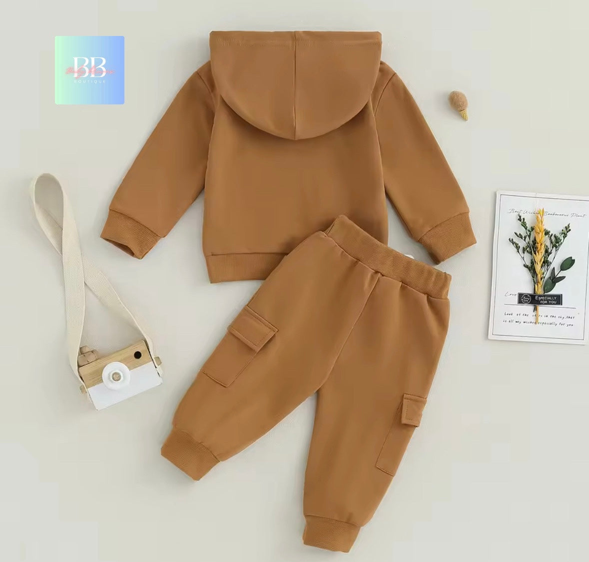 Brown children's hoodie and pants set on a light gray background with a BB logo.