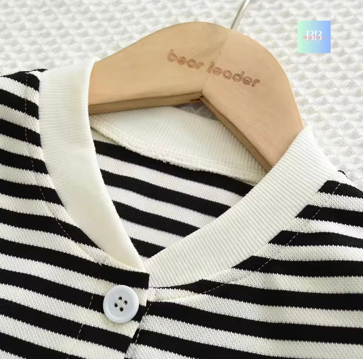 Black and white striped garment on a hanger with 'bear leader' branding.