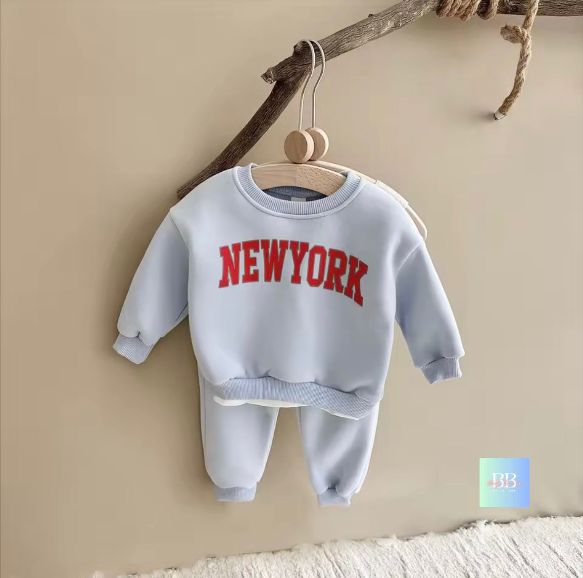 Children's sweatshirt and pants set with 'NEW YORK' text on a beige background