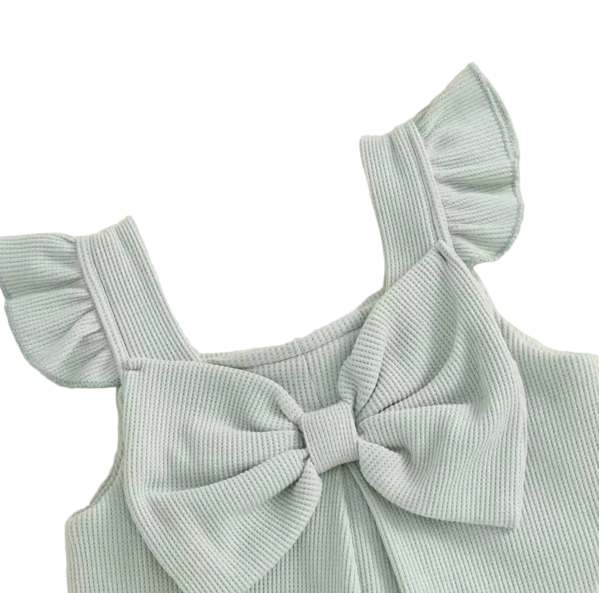 Light blue dress with ruffled straps and a large bow on a beige background