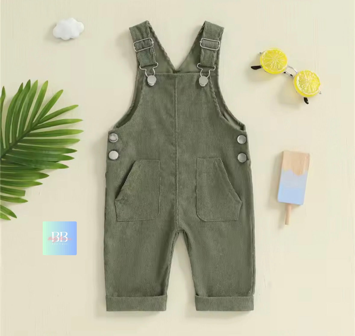 Green overalls with buttons on a light beige background