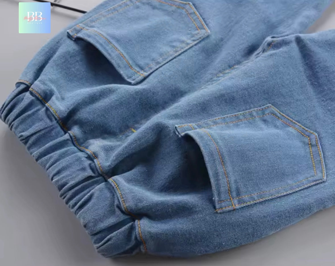 Close-up of blue denim pants with a plain background