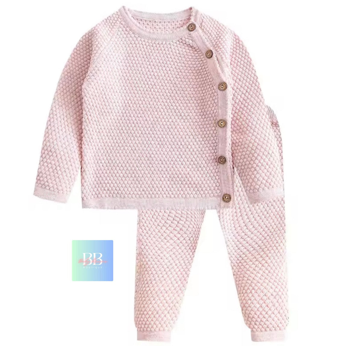 Pink textured baby outfit with buttons on a white background
