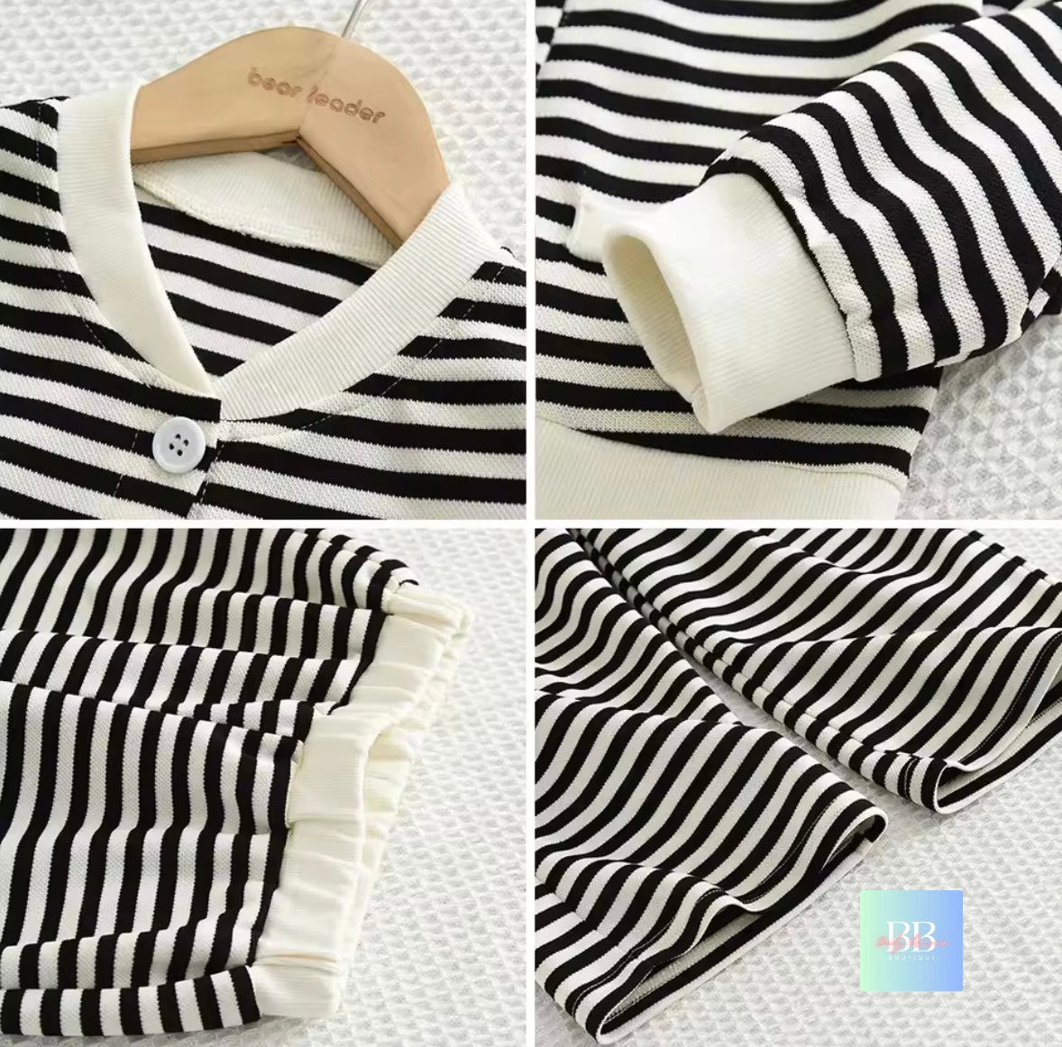 Black and white striped baby outfit on a hanger with close-up details.
