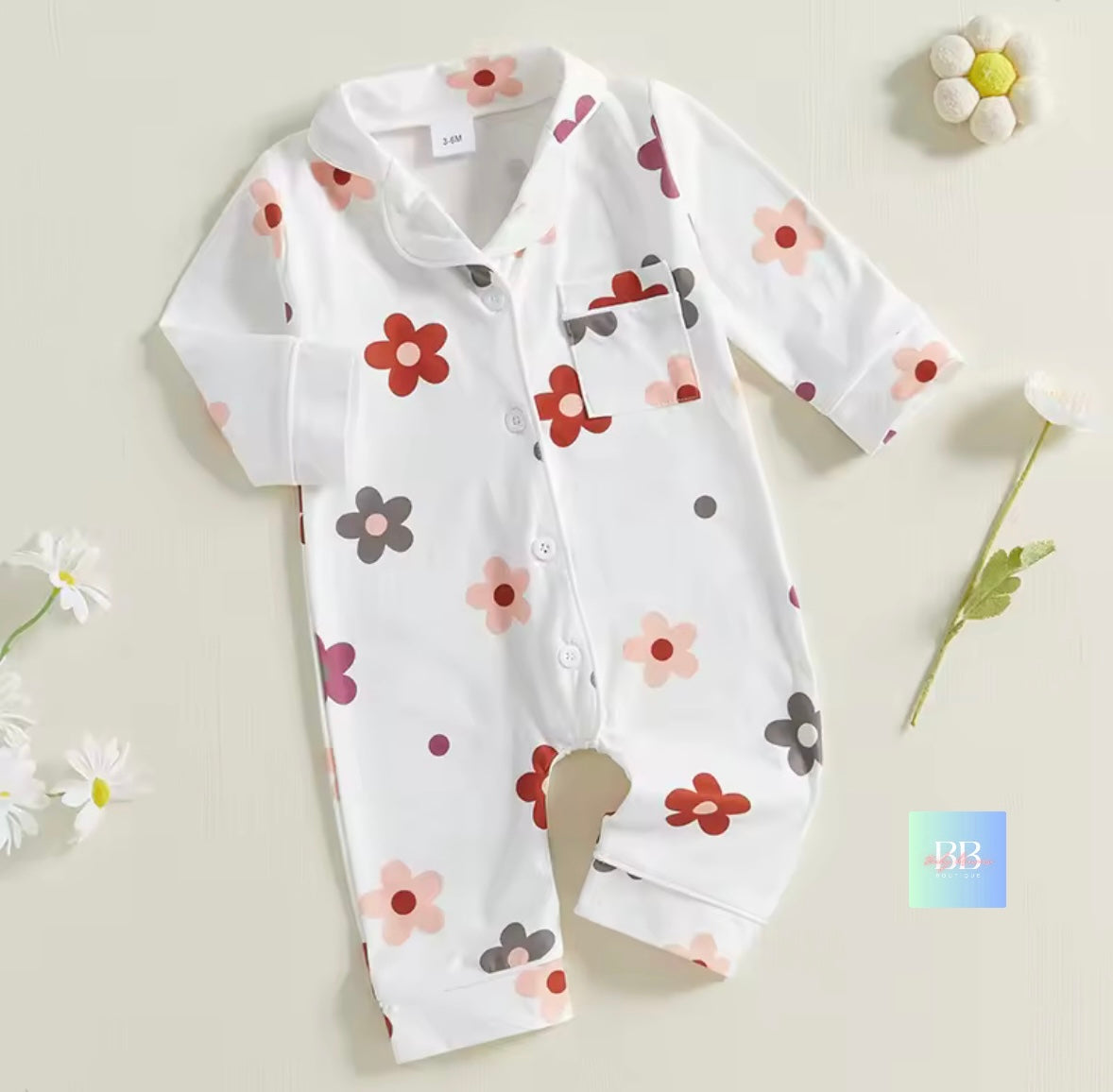 Baby onesie with floral pattern on a light background