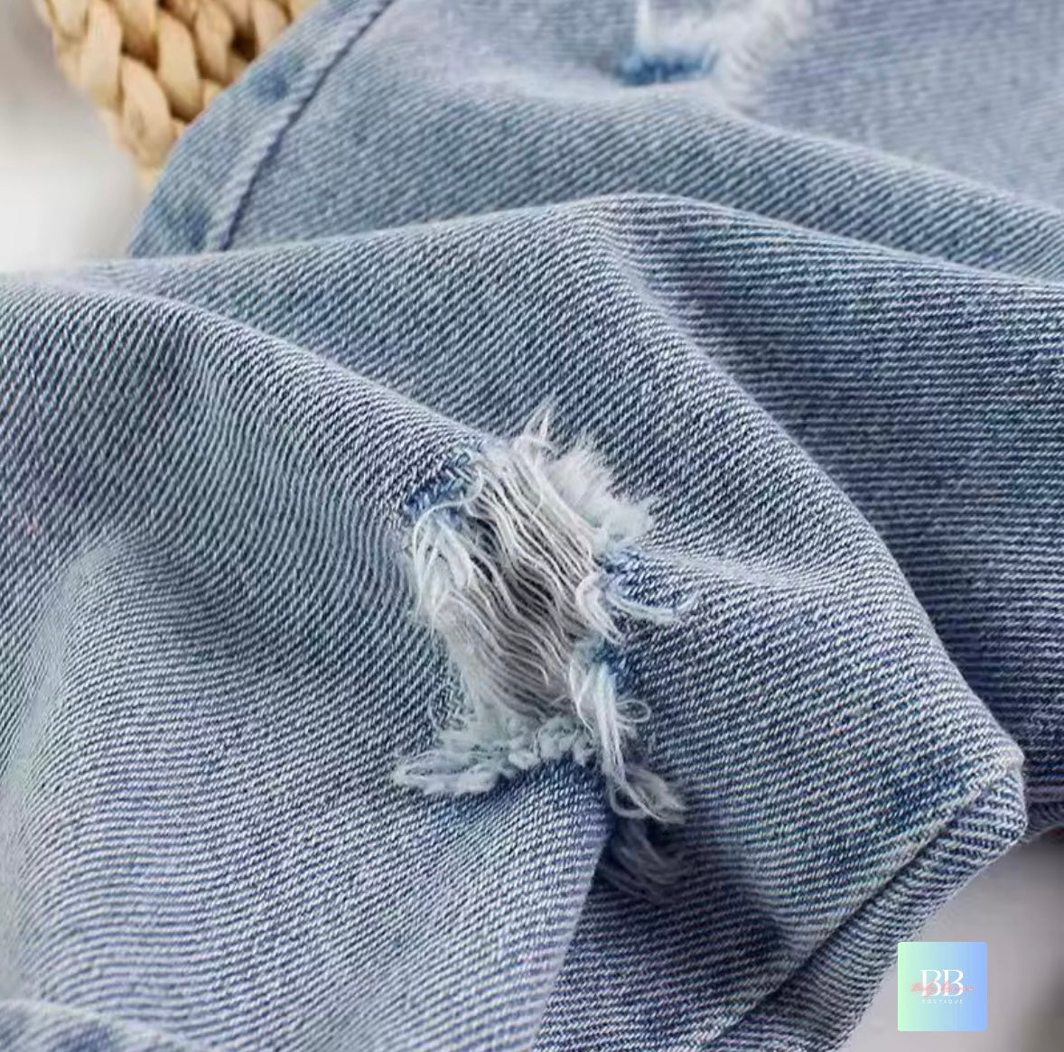 Close-up of blue denim fabric with frayed edge