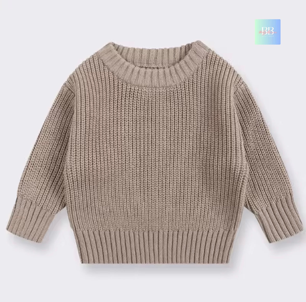 Beige knitted sweater on a light gray background