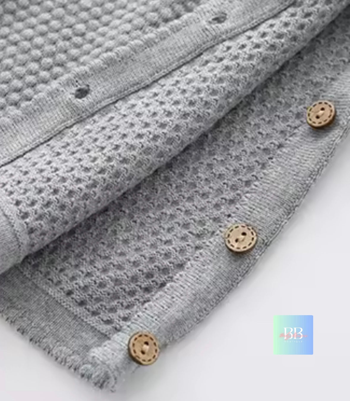 Gray textured fabric with wooden buttons on a white background