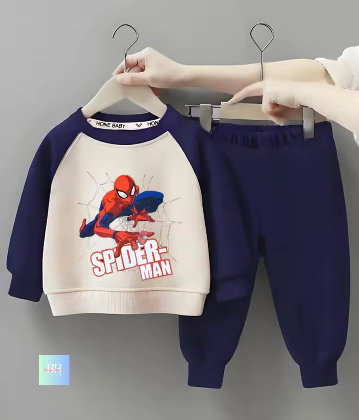 Children's Spider-Man outfit on hangers against a gray background