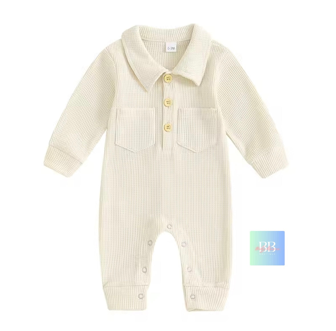 Baby romper with long sleeves and button details on a white background