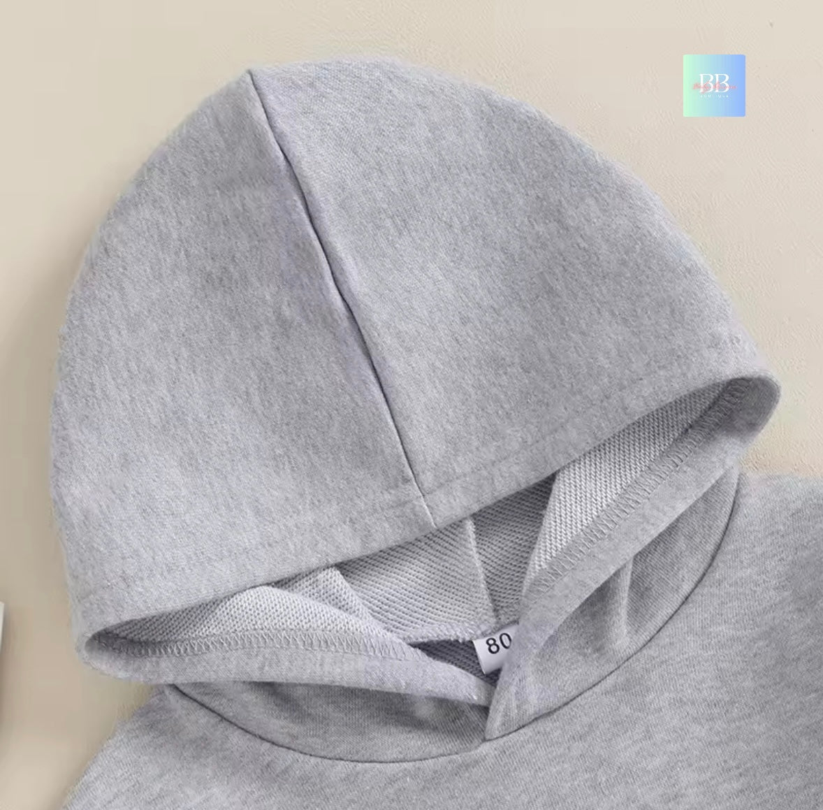 Gray hoodie with a hood on a beige background