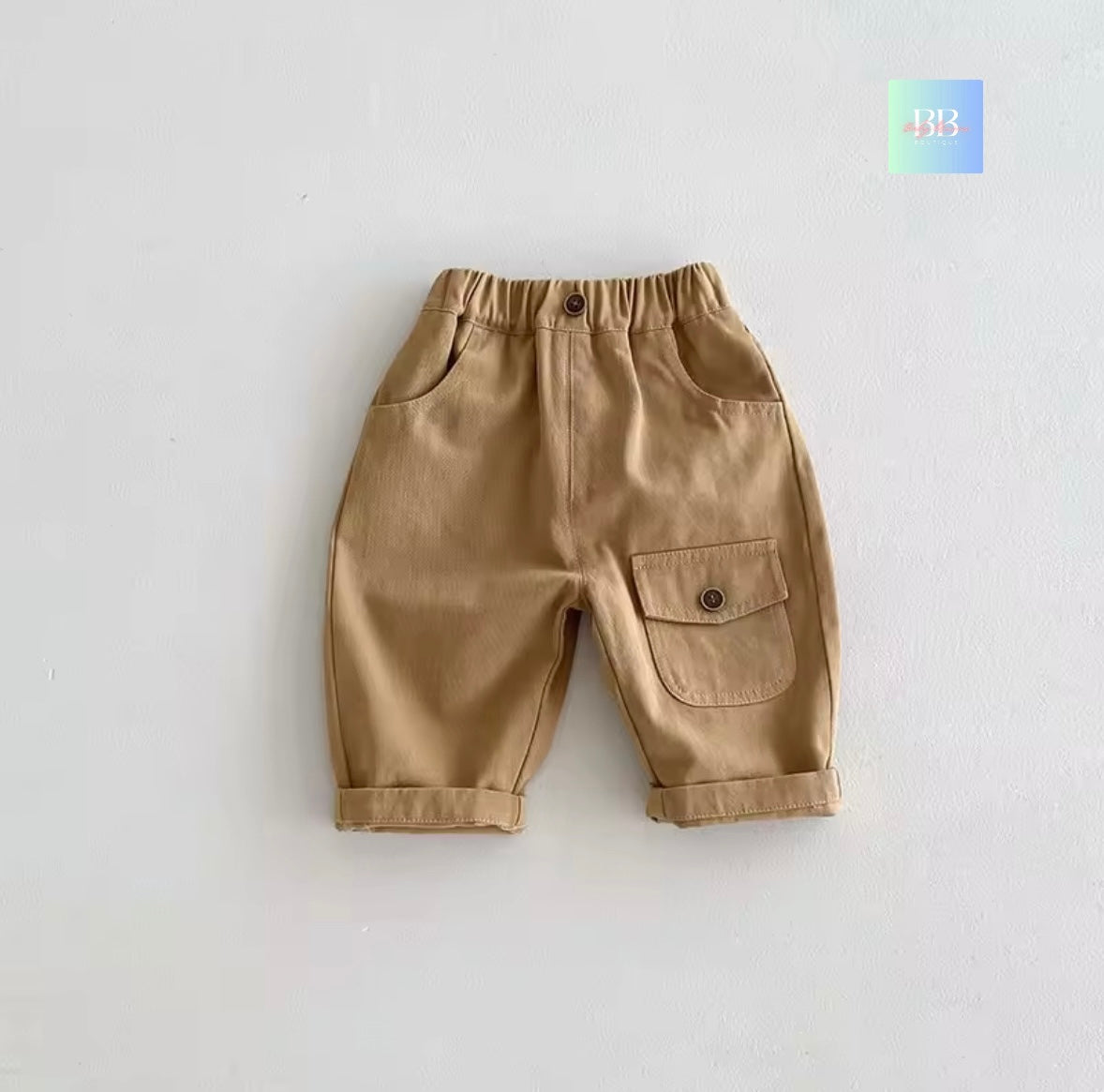 Beige children's pants with a pocket on a light gray background