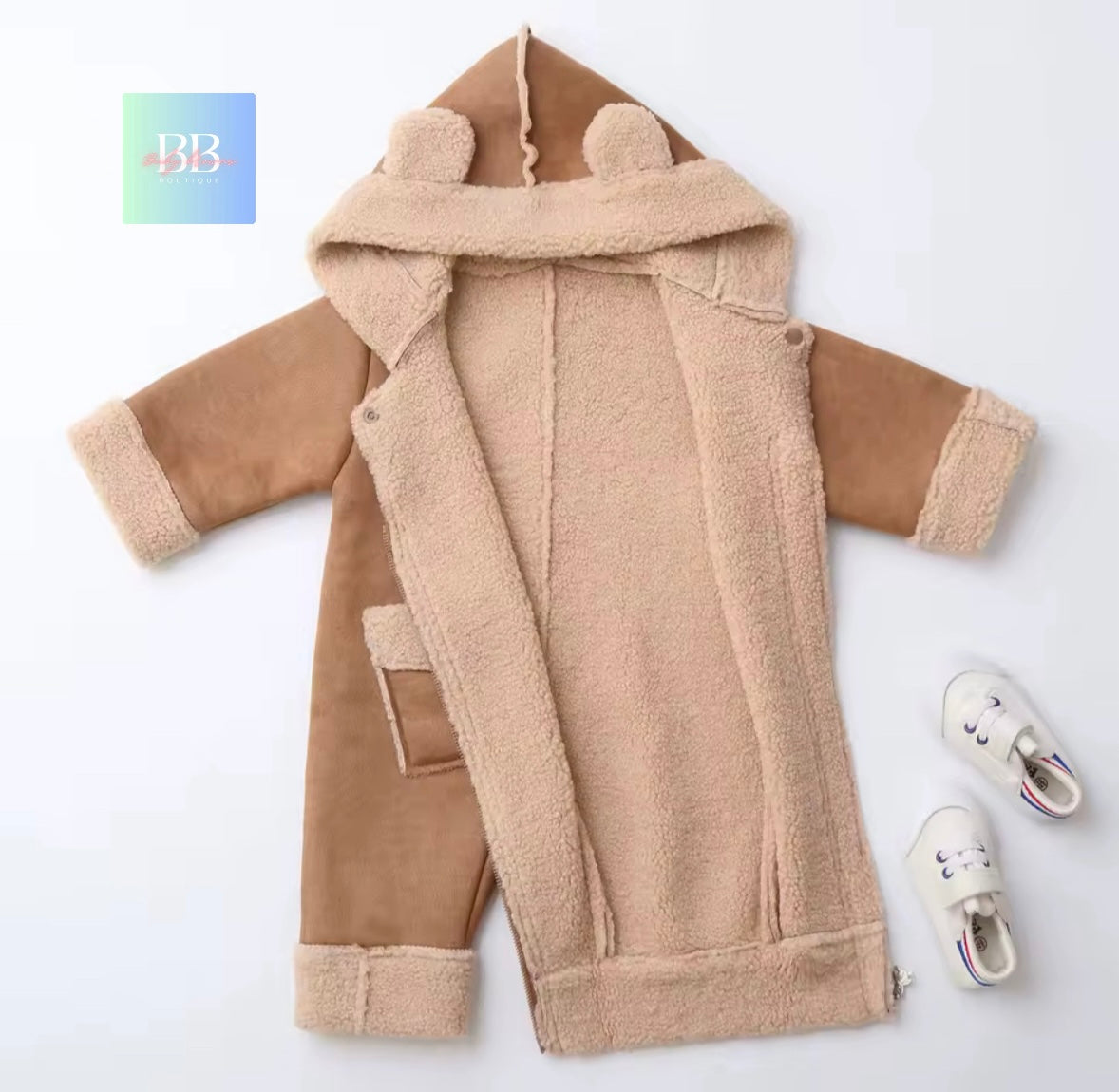 Beige baby onesie with bear ears on a white background