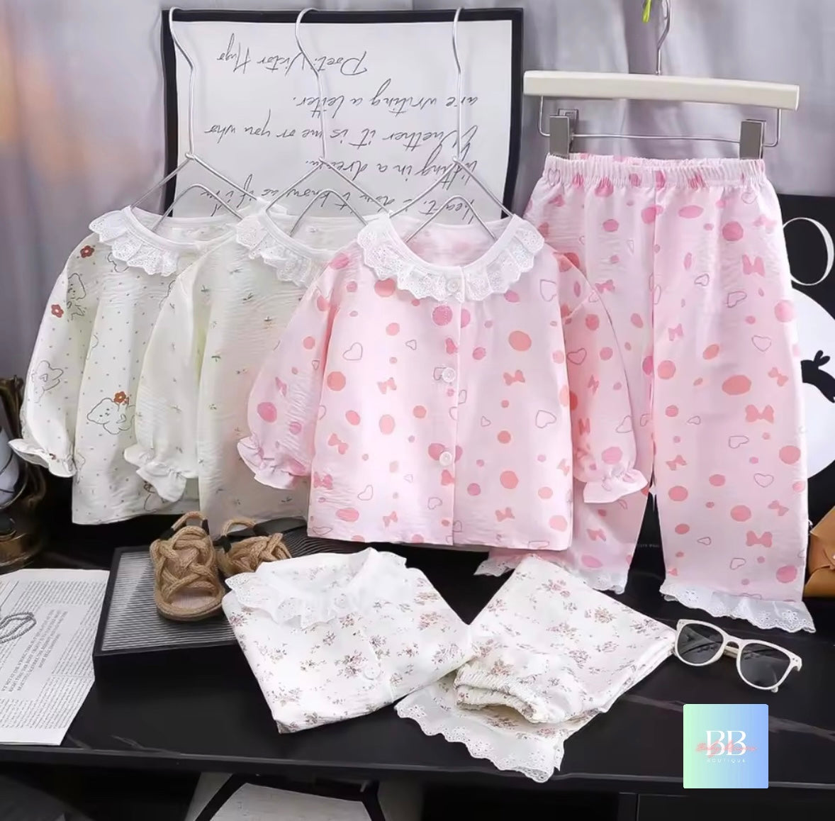 Children's pajama set with polka dot shirt and pants on a table.
