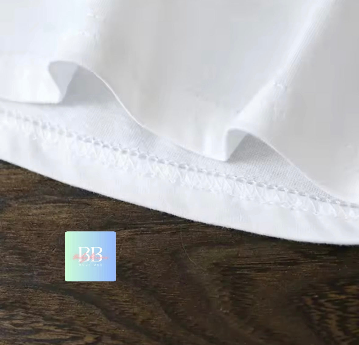 White shirt collar on a wooden surface with a brand label.