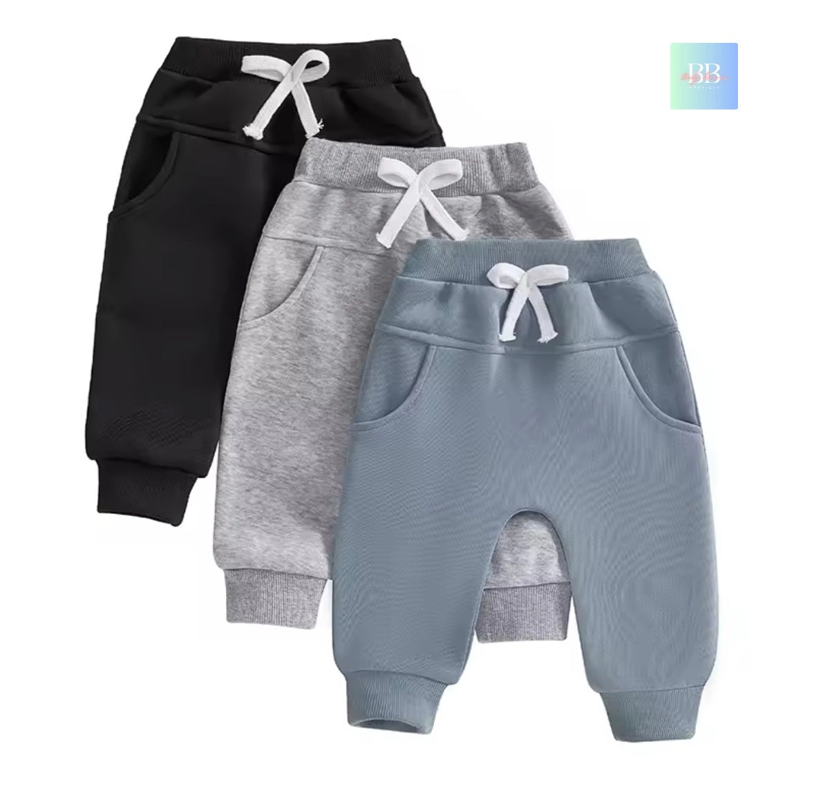Three pairs of baby pants in black, gray, and blue on a white background.