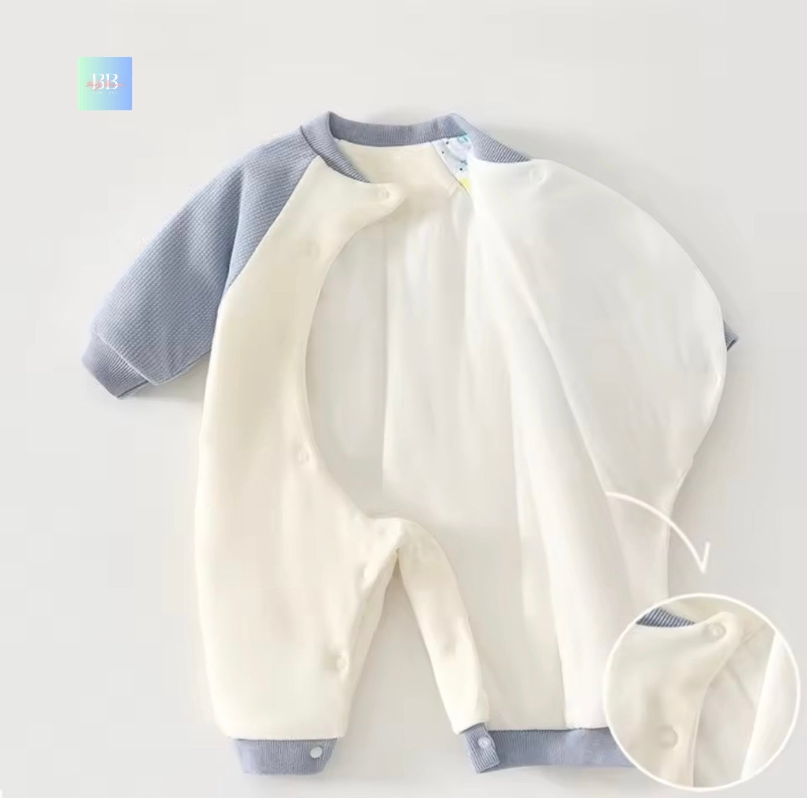 Baby romper with blue sleeves and collar on a light gray background