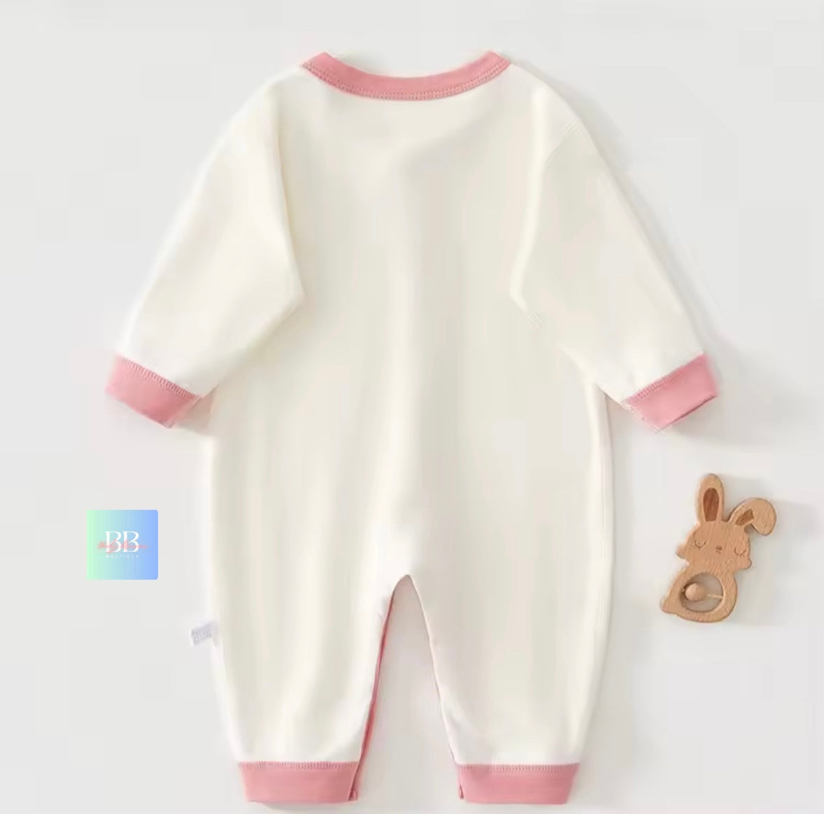 White baby romper with pink trim on a white background