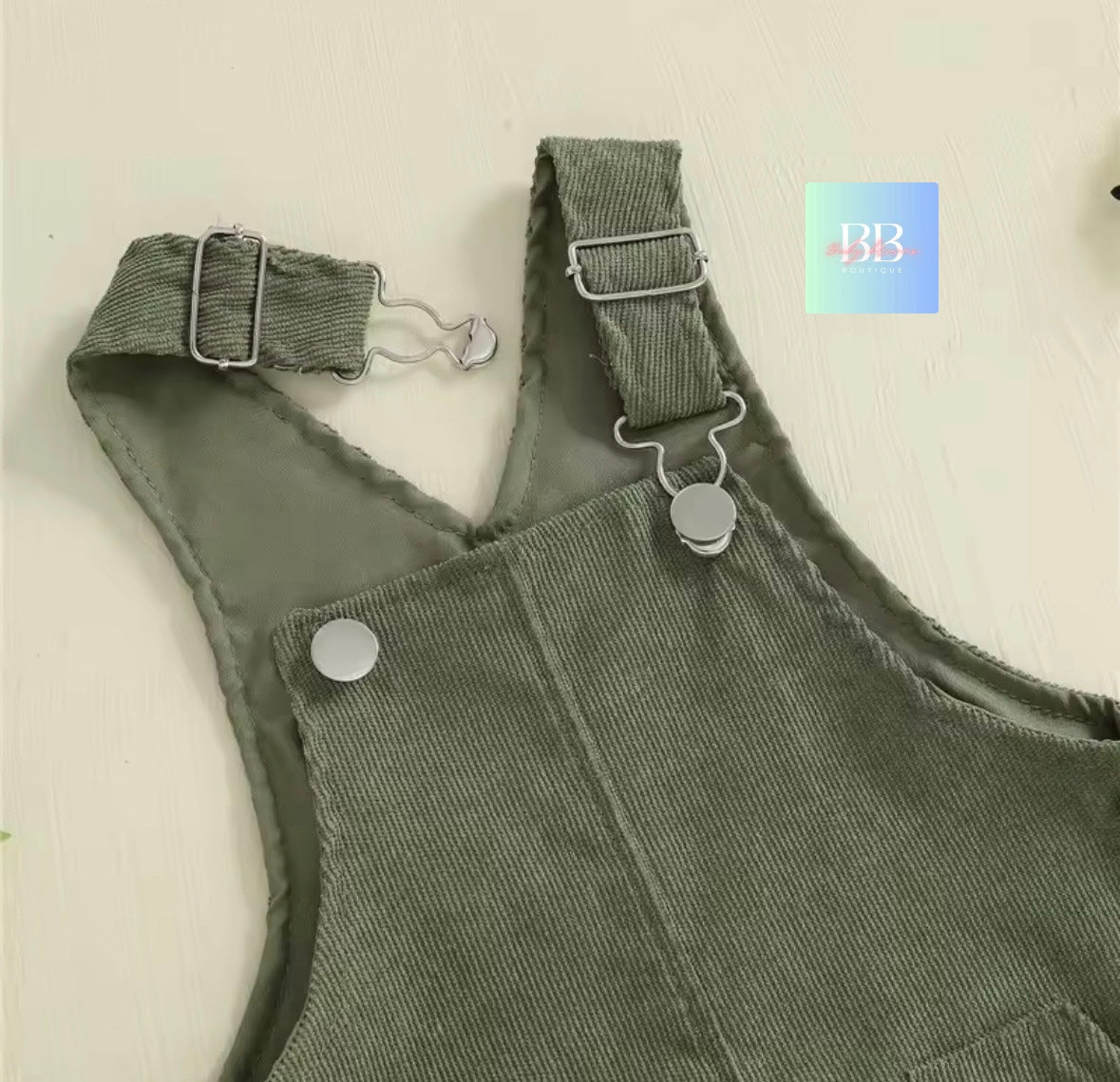 Green overalls with suspenders on a light background