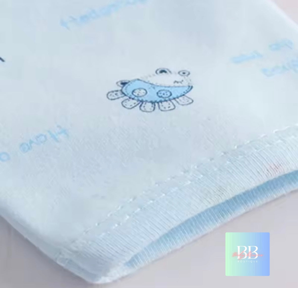 Baby blanket with a blue fish design on a light background