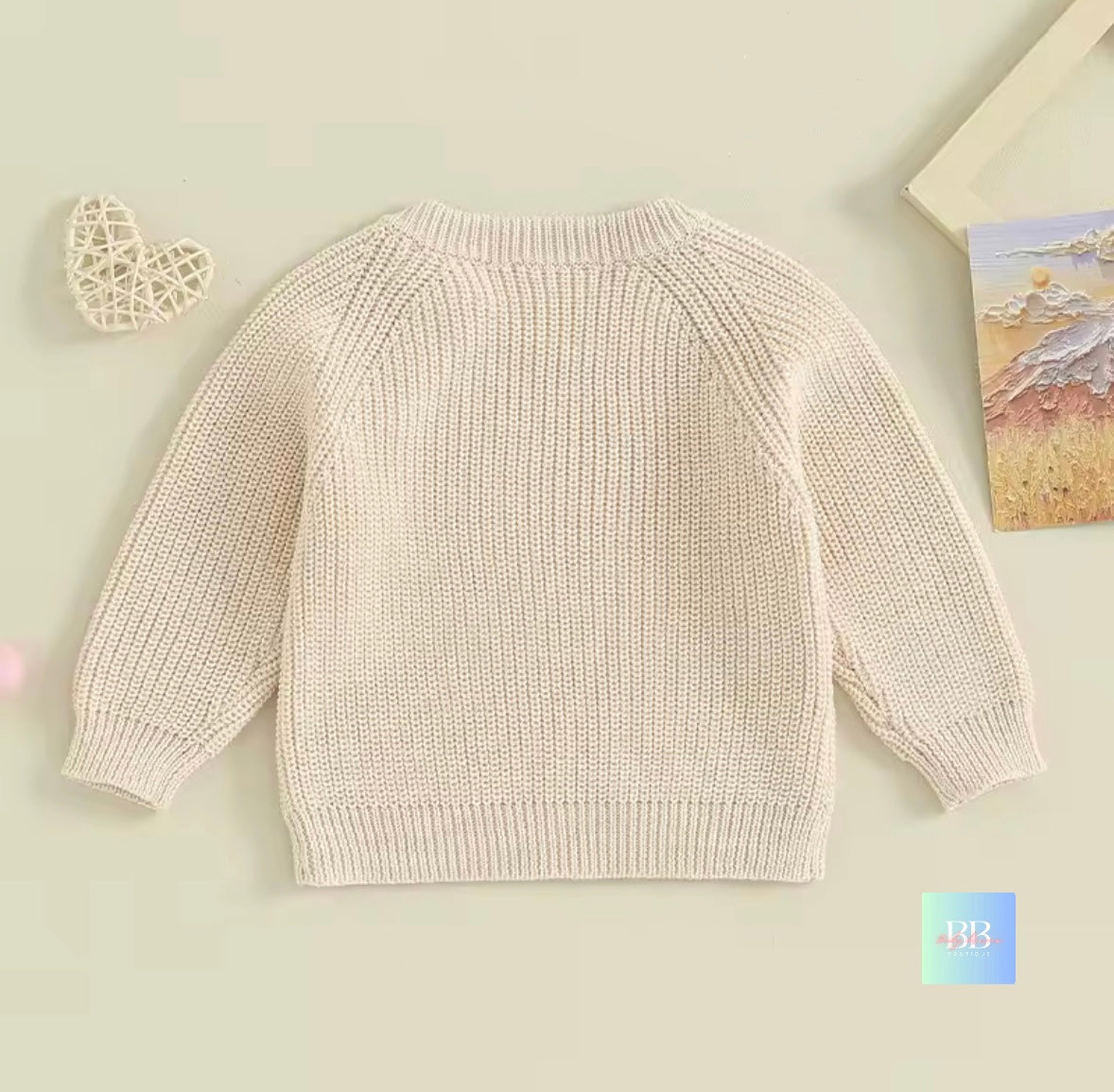 Beige knitted sweater on a light beige background