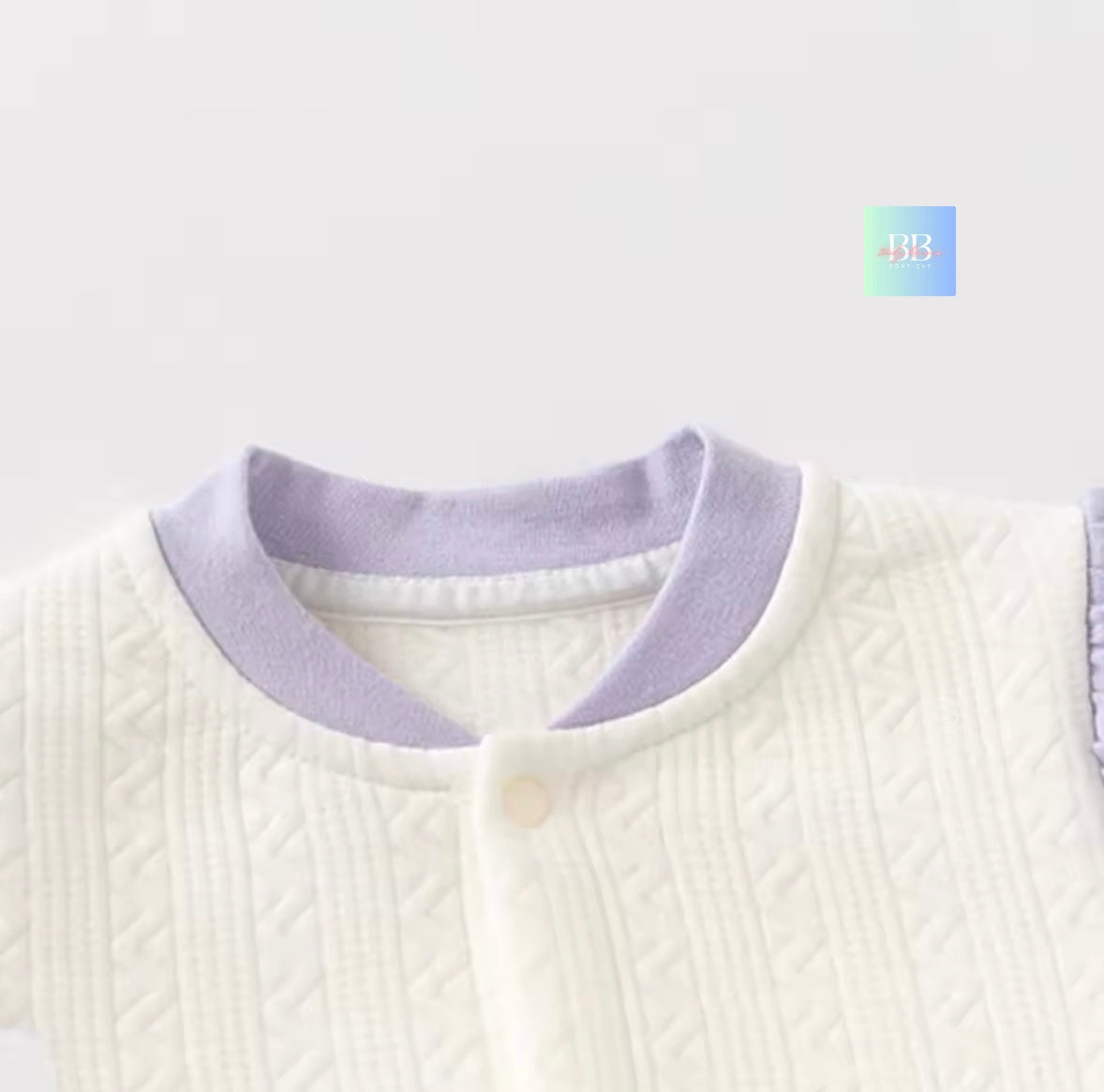 White sweater with a purple collar on a white background