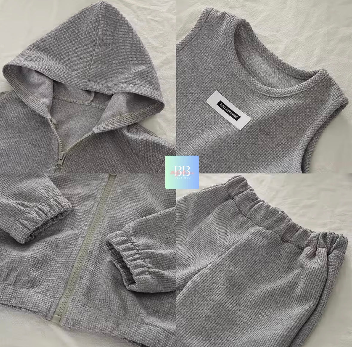 Gray tracksuit with a brand label on a light background